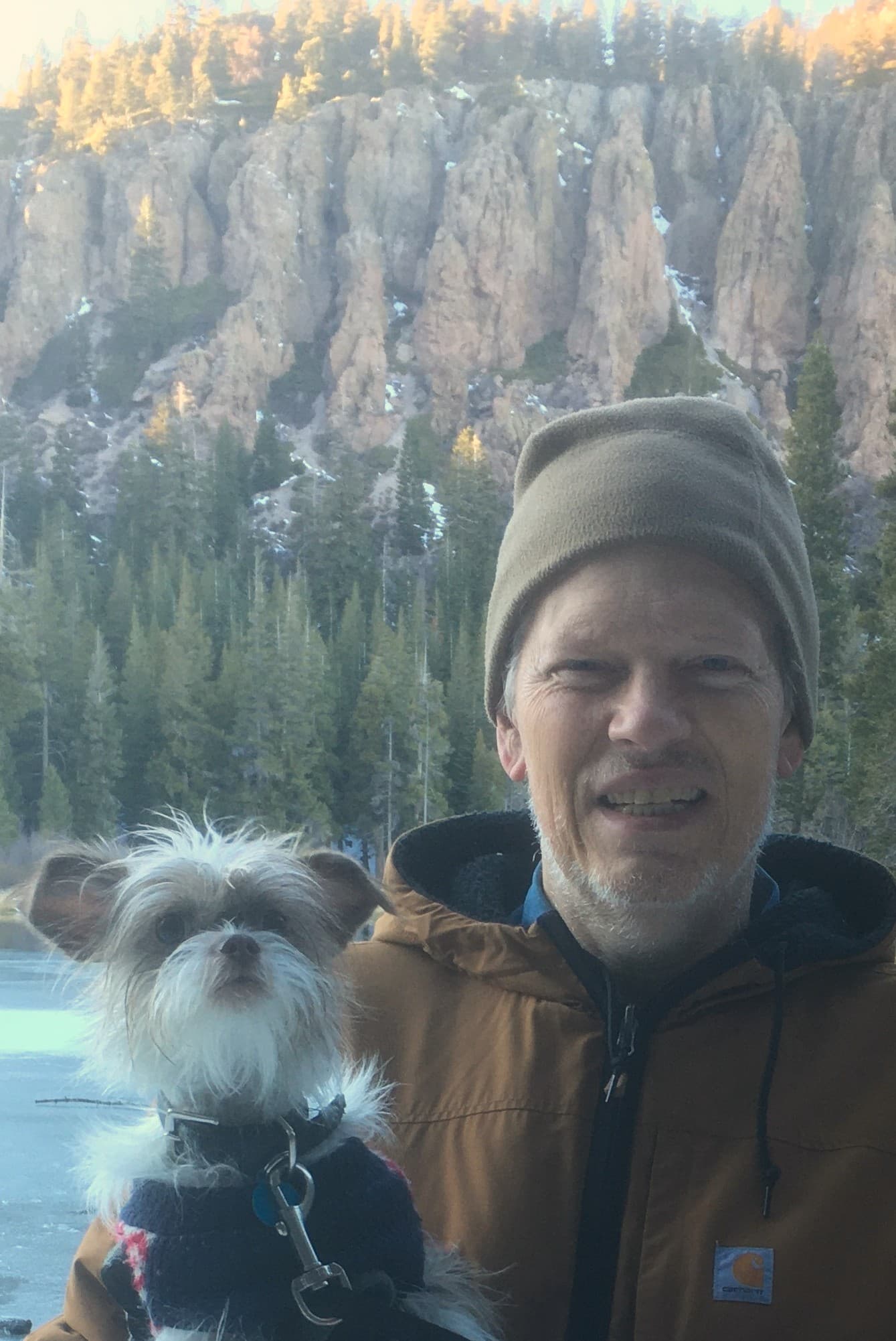 Gaylon TeSlaa, DVM, with his dog in front of granite cliffs in the Eastern Sierra